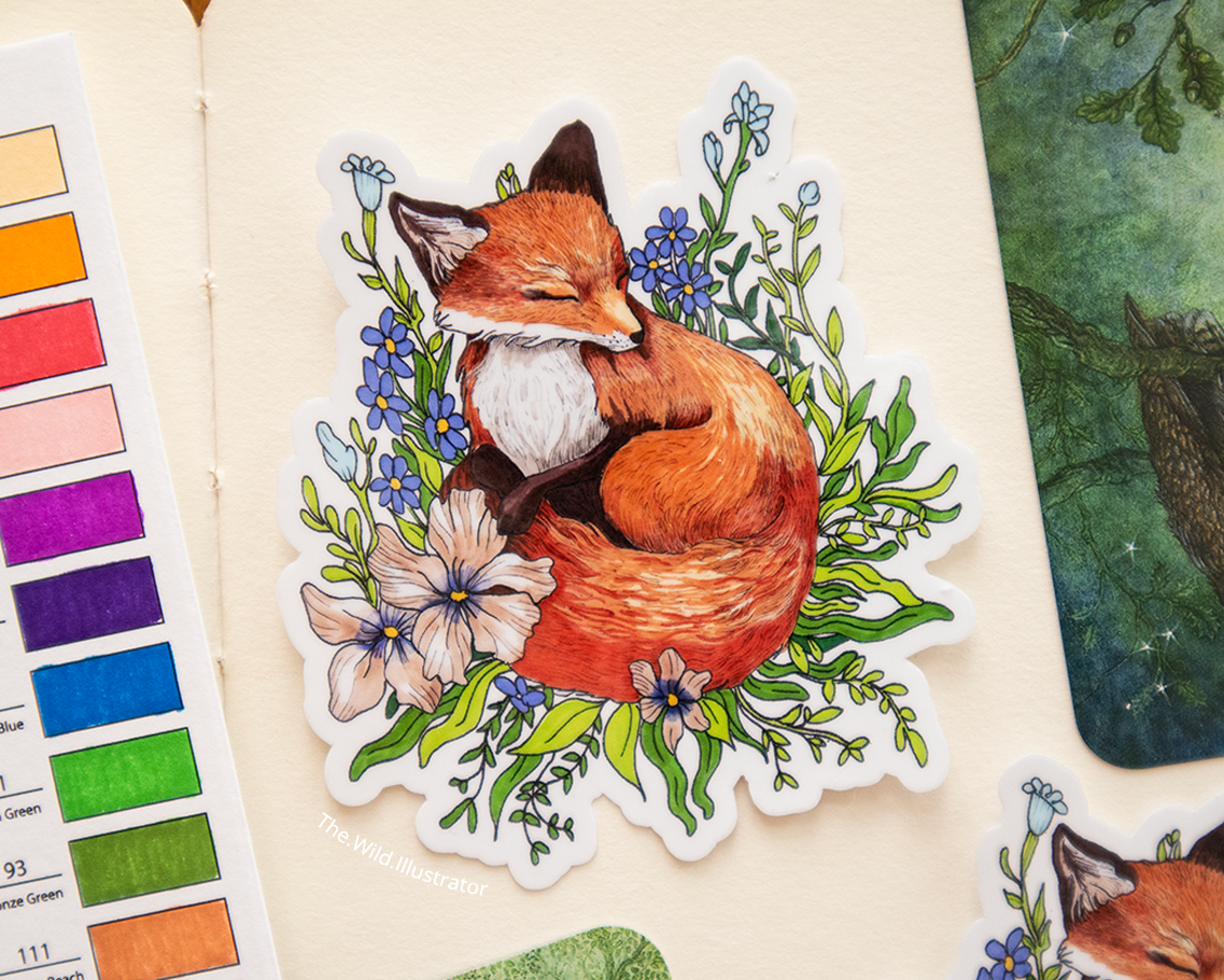 Sticker of a sleeping fox nestled in wildflowers, in soft natural tones.