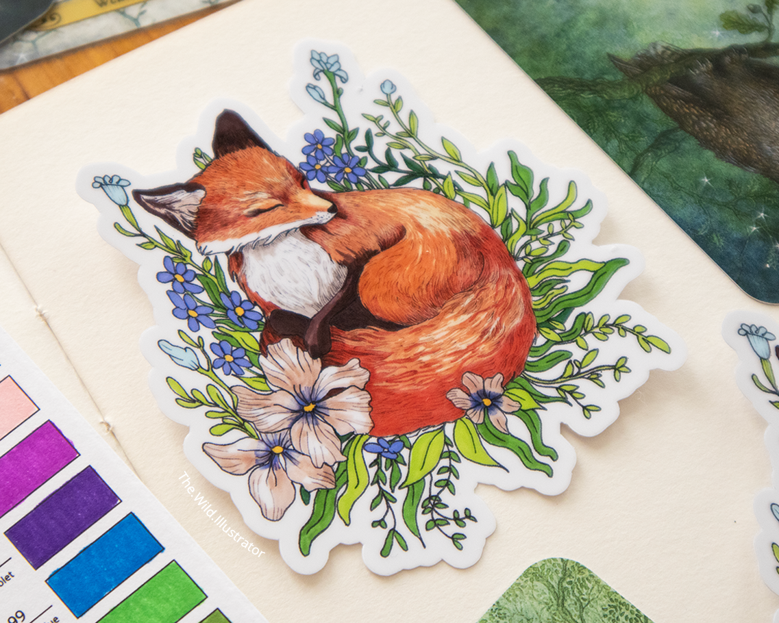 Sticker of a sleeping fox nestled in wildflowers, in soft natural tones.