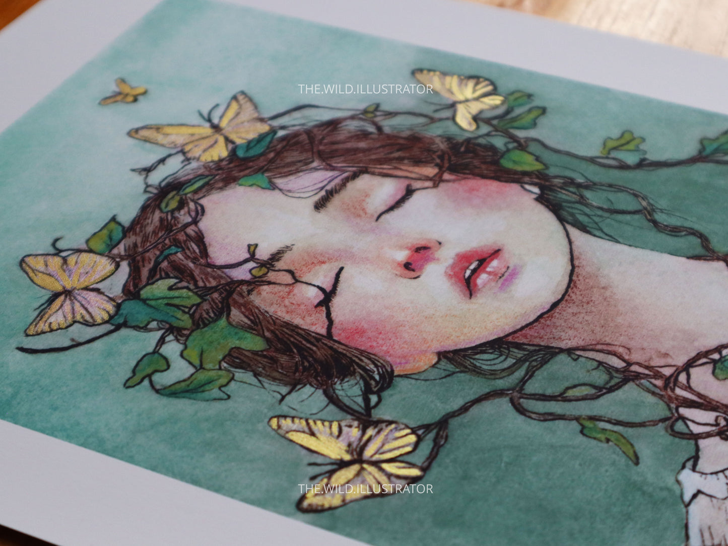 Art print of a woman with vines and golden butterflies in pastel tones, printed on fine art paper. Optional hand-embellished gold accents available, shown in A4 size.