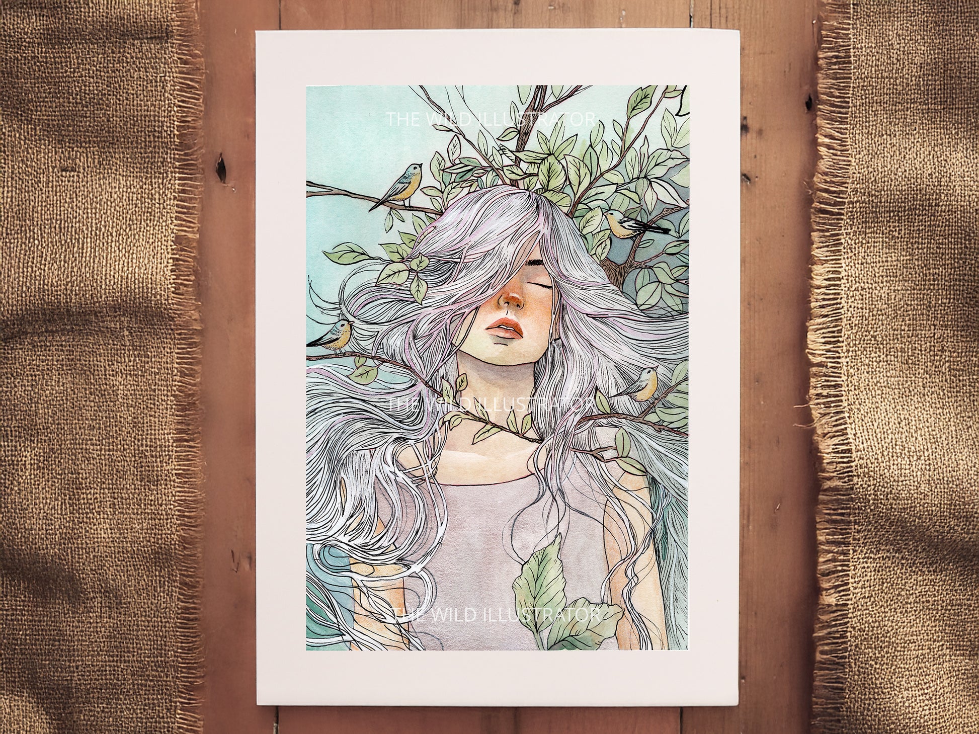 A high-quality art print of a watercolor painting featuring a woman surrounded by foliage and birds. Printed on archival paper, available in A6, A5, and A4.