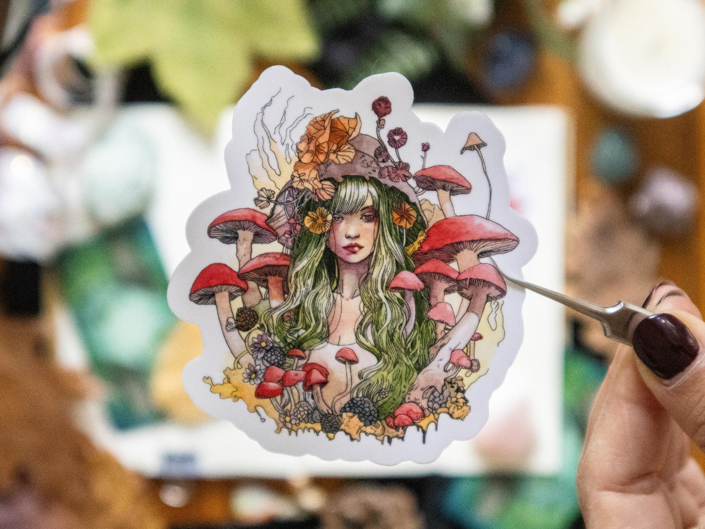 Handmade vinyl sticker featuring a mystical woman surrounded by mushrooms, ideal for journals, laptops, and water bottles.